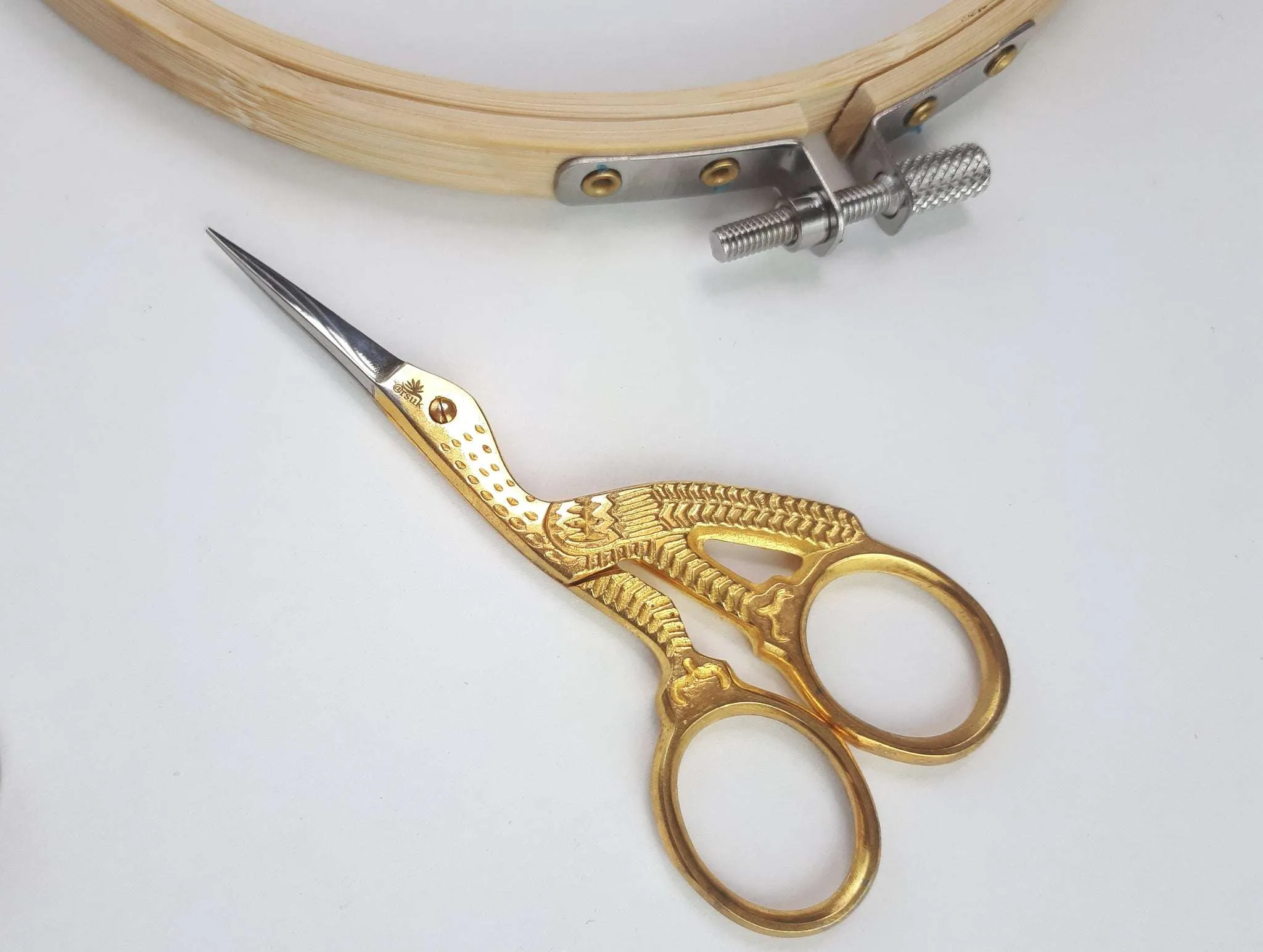 Small gold embroidery scissors shaped like a stork