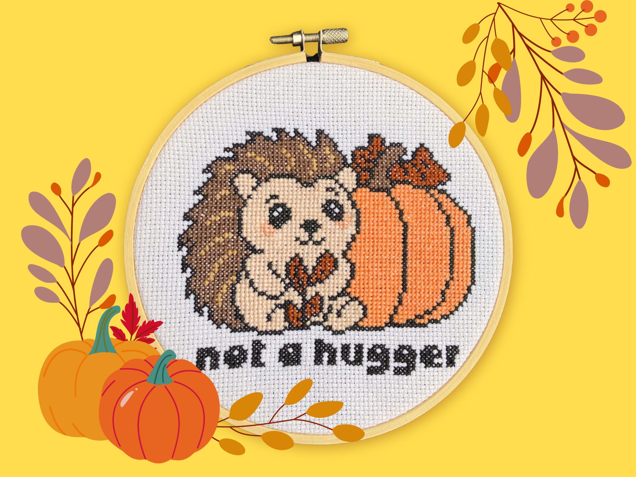 Cute Cross Stitch Hedgehog with pumpkin, the words 'not a hugger' below