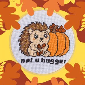 Funny hedgehog cross stitch with pumpkin, autumn theme.